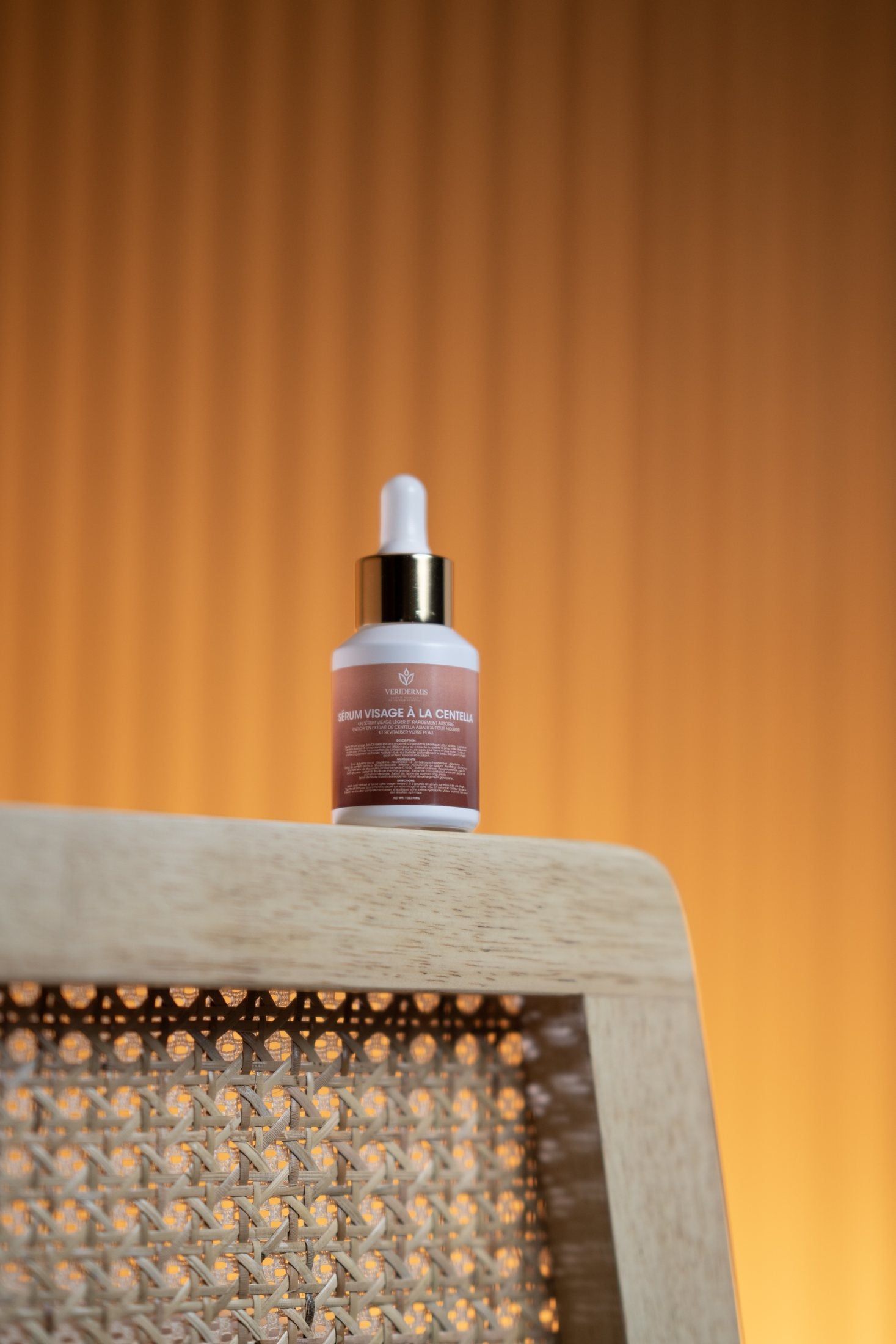 Real Veridermis Centella Face Serum on a warm brown background